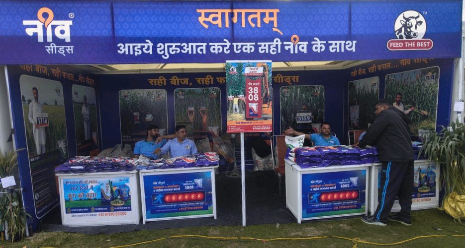 Neev Seeds exhibition stand with a blue welcome banner and product displays