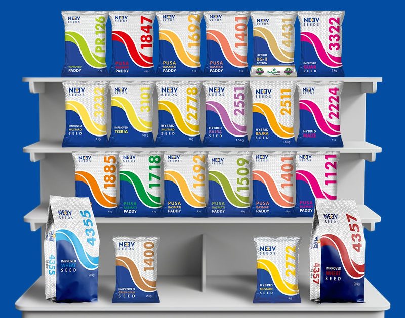 Neev Seeds field seed packets on a shelf, each with a single colour strip