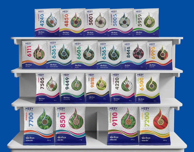 Neev Seeds vegetable seed packets on a shelf, with a double colour strip and a clear window