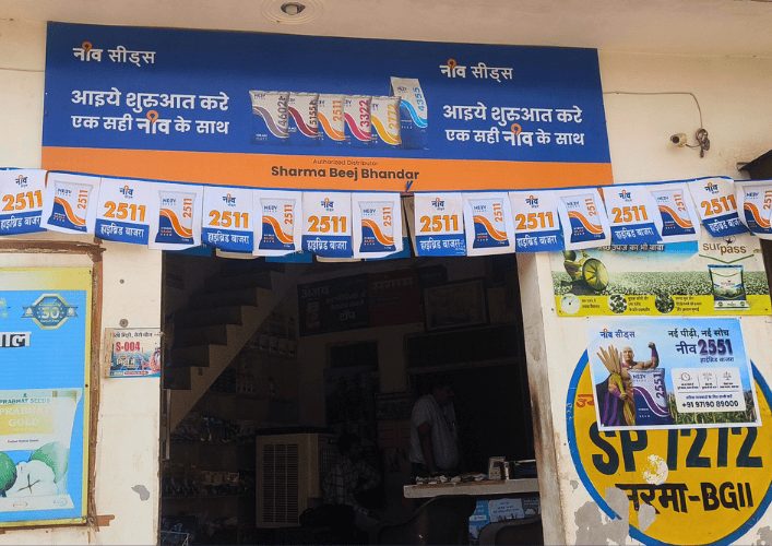 Seed shop front branded with Neev Seeds boards and posters